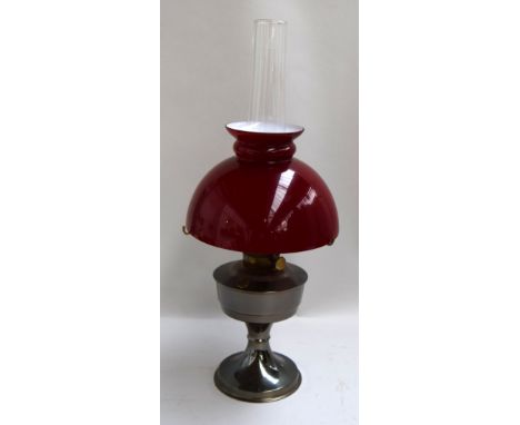 An Aladdin 25 gas lamp with red glass shade and chimmney