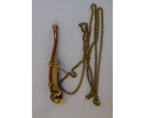 A copper and brass bosun's whistle on a chain with copper anchor decoration to end
