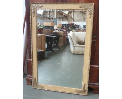 A large rectangular mirror with floral carved banding 100 x 152cm