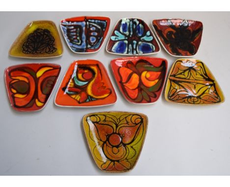 Nine Poole pottery Delphis ware triangular side plates (9)