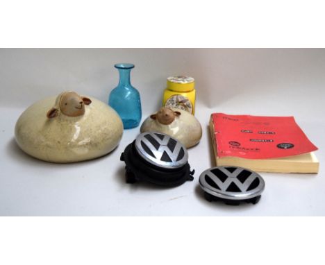 A mixed lot to include two large ceramic ornaments of sheep, a ginger jar, two VW badges and other items