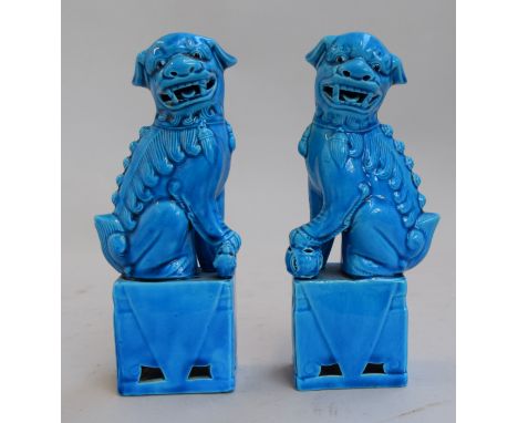 A pair of Chinese blue coloured ceramic foo dogs on plinths 21cmH