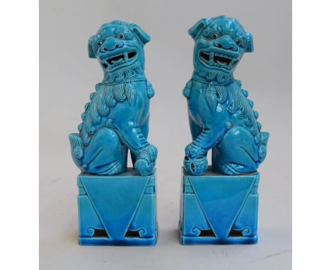 A pair of Chinese blue coloured ceramic foo dogs on plinths 20.5cmH