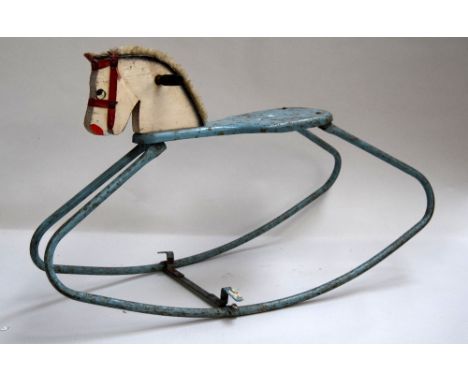 A vintage childs rocker with the head of a horse to the front