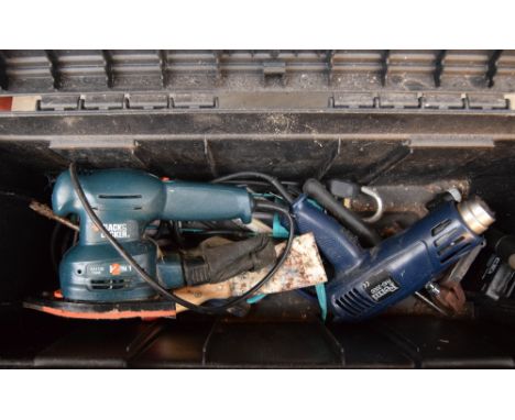 A toolbox containing a hand sander and other tools