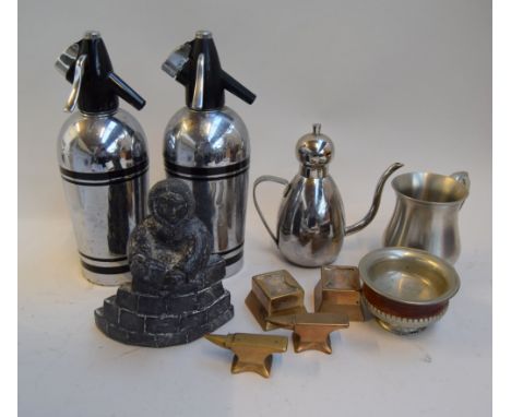 A mixed lot to include two vintage soda siphons, two paperweights in the forms of anvils and a figure of an Eskimo building a