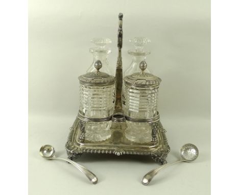 A George III silver cruet set, the silver base with hoop handle, gadrooned edge, raised on four lions paw feet, London 1820, 