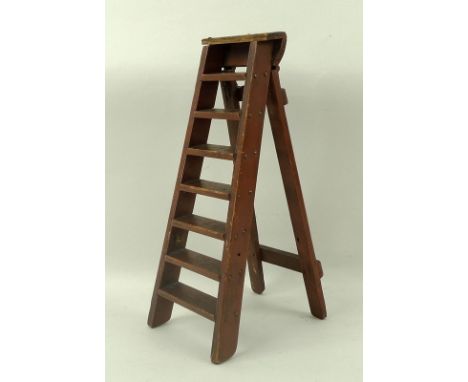 A mahogany apprentice or salesman's model of a miniature step ladder, early 20th century, painted dark red, 10 by 20 by 24cm 