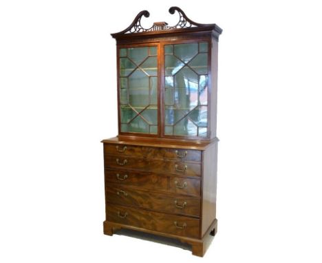 A George III mahogany secretaire cabinet, circa 1775, the acanthus carved fretwork swan-neck pediment above a pierced dentil 