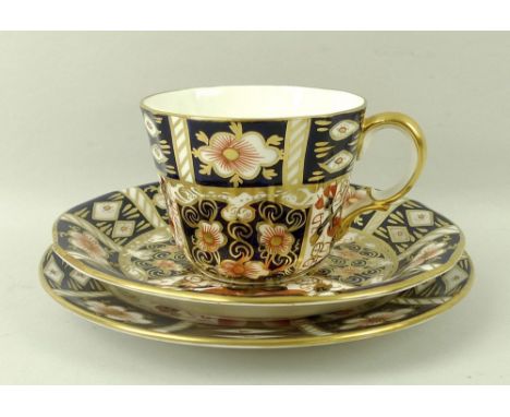 A Royal Crown Derby part teaset, decorated in gilt-heightened Imari palate, comprising six tea cups, saucers and plates, a pa