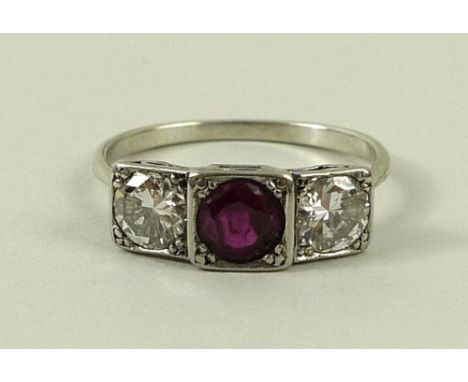 An Art Deco diamond and ruby ring, the central ruby flanked either side by a 0.5ct diamond, size O, 2.6g total weight.