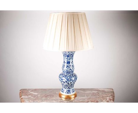 A modern Oriental blue and white porcelain baluster vase table lamp, with a turned gilt base. With ivory, fabric shades 68 cm