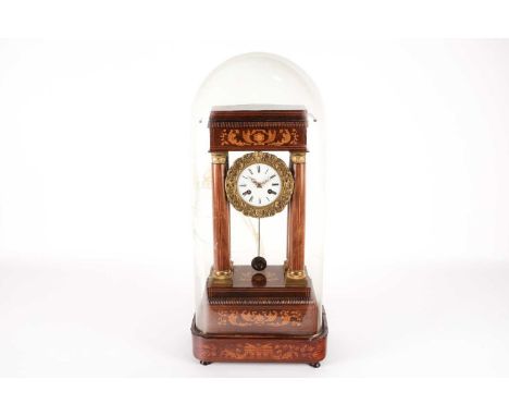 A French Charles X  rosewood portico clock under a glass dome. The clock chiming the hours and marking the half-hour with a p