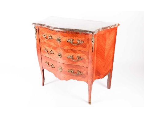 A French Louis XV style marble topped serpentine Kingwood and tulipwood three-drawer commode, with ormolu mounts and handle. 