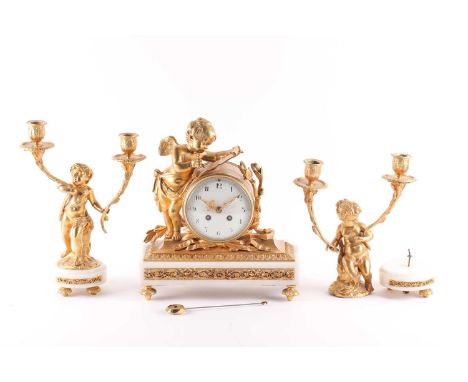 An early 20th-century French ormolu and white marble clock garniture. The 8-day drumhead clock chiming the hours and half hou