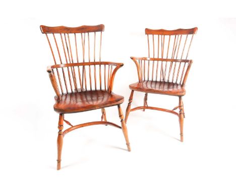 A pair of craftsmen made 20th century "Comb Back" ash and elm Windsor armchairs with cupids bow cresting over a saddled seat.