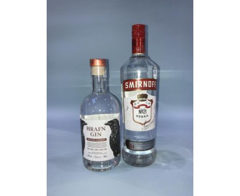 A bottle of 'Hrafn Gin' and a bottle of Smirnoff vodka