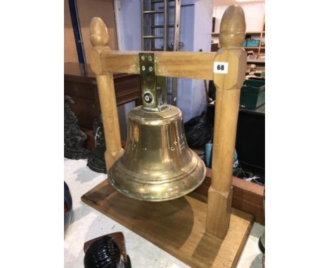 A large ships bell on light oak stand, off 'The Crista 1938'