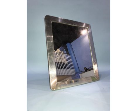 A silver framed easel mirror
