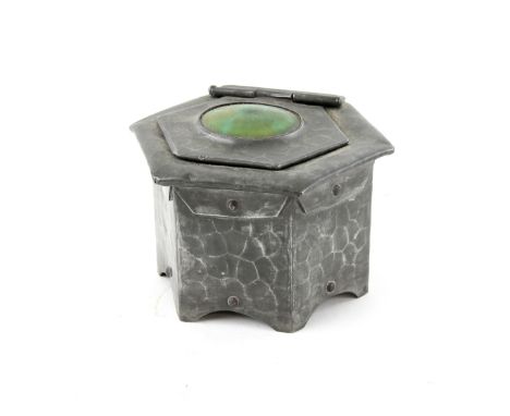 Hammered pewter inkwell of hexagonal form with central green Ruskin type roundel to the lid, unmarked, 7.5cm high.    Central