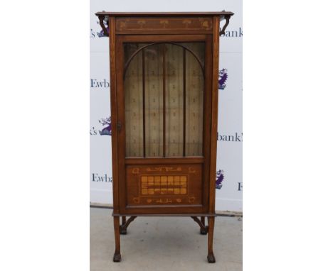 A mahogany  glazed cabinet inlaid with satinwood a design of ivy leaves and floral posies, the lower door with landscape moti