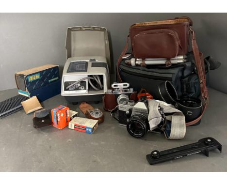 A Halina camera and camera equipment along with an Aldis slide projector and a Praktica 35mm camera and lenses