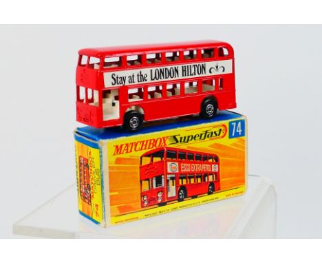 Matchbox - A boxed Daimler Bus # 74 in the sought after Hilton livery with Kensington on one side and London on the other. It