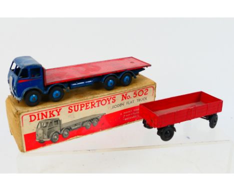 Dinky Toys - A boxed Dinky Toys #502 Foden Flat Truck (1st Type). The model with dark blue cab, chassis and light blue hubs, 