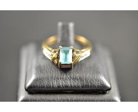 A 9ct gold amethyst and blue topaz 'reverso' ring with diamond set shoulders - size O 1/2, approx gross weight 3g.CONDITION R