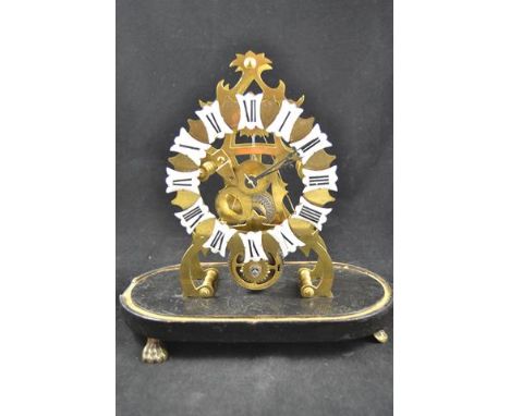 A 19th century single fusee skeleton clock, enamel numerals, under glass dome, standing on paw feet - height of clock 23cm, o