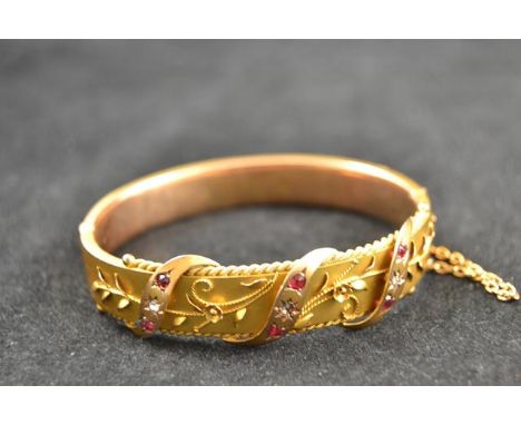 A 9ct gold bangle decorated with diamonds and rubies, floral filigree work, maker NBs - approx gross weight 17.1gCONDITION RE