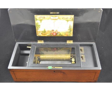 A late 19th/early 20th century Swiss music box,15cm cylinder playing 8 airs, pictorial playlist to interior of lid, movement 