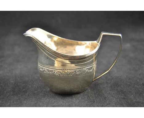 An early 19th century engraved silver helmet shaped cream jug, London 1806, makers mark rubbed - approx weight 84g/2.7 troy o