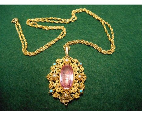 A yellow metal (tests as 15ct gold) filigree pendant set with central pink topaz, bordered by four seed pearls and four small