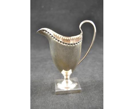A Georgian style silver helmet shaped cream jug, beaded decoration to border, square base, Chester 1901 - approx weight 90g/2