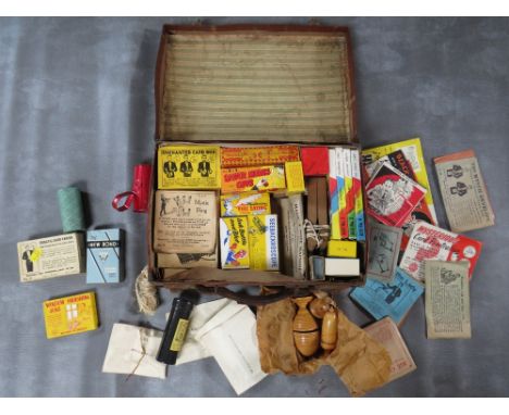 A SMALL LEATHER CASE FULL OF VINTAGE MAGIC TRICKS 