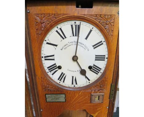 A WALL MOUNTED NATIONAL TIME RECORDER OAK CASED CLOCKING IN CLOCK, H 119 cm 