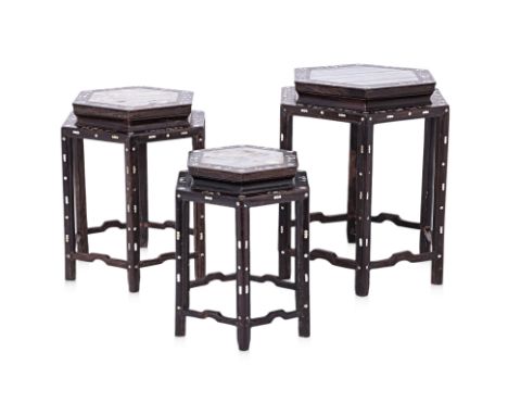 A GRADUATED SET OF THREE MARBLE INSET HEXAGONAL STANDS
The blackwood frames with mother of pearl inlaid foliate decoration an