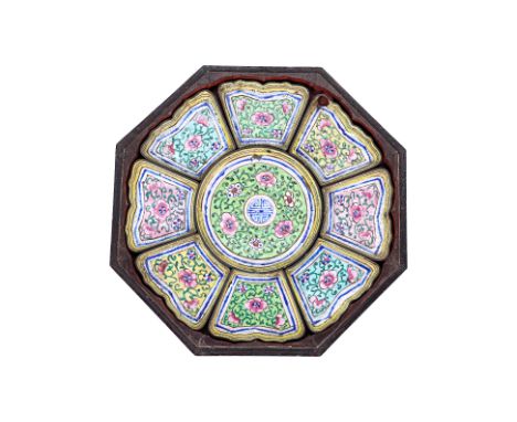 A CANTON ENAMEL SWEETMEAT SET
The octagonal lacquer box with figural decoration to the cover, containing a set of nine multic