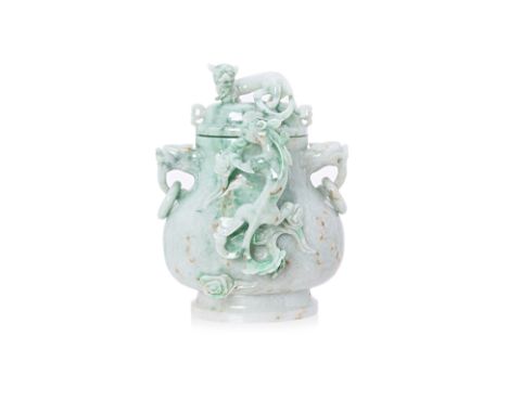 A CARVED JADE TWIN HANDLED VASE AND COVER
Decorated with dragons and with dragon mask drop ring handles
12cm high
Condition: 