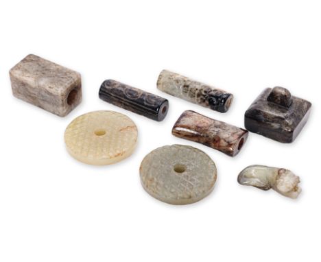 A GROUP OF EIGHT SMALL JADE OBJECTS
To include two similar discs; a square seal; cylindrical and square section beads; and a 