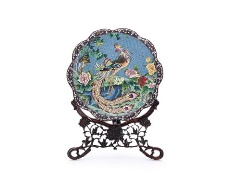 A LARGE CLOISONNE ENAMEL PHOENIX AND PEONY CHARGER Circular with shaped rim, decorated with a phoenix perched on a rock among