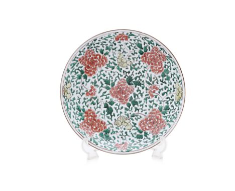 A LARGE FAMILLE VERTE 'PEONY' PORCELAIN DISH Decorated with trailing iron red and yellow flowers within scrolling foliage, br