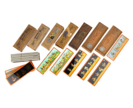A Collection of Childrens Magic Lantern Slides Comprising of 2 sets in pine cases with a trade label for 'Fabrik J. F. Marke'
