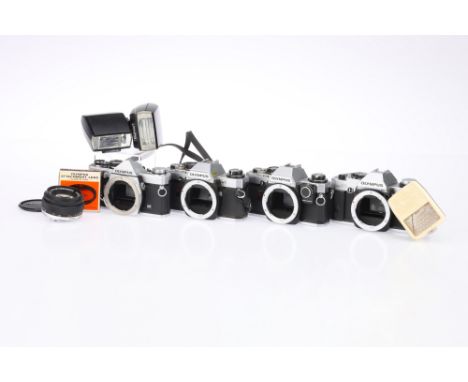 Four Olympus OM Series 35mm SLR Cameras, to include an Olympus OM-2n, body G-VG, shutter working when batteries are inserted,