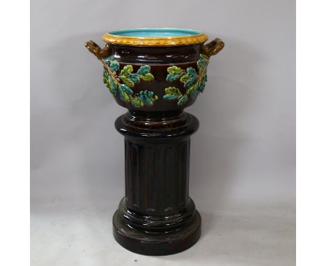 A large Sarreguemines Majolica pottery jardiniere on stand, model no. 1649, with relief applied acorn and oak leaf decoration