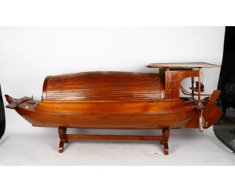 A large Oriental hardwood table-top model sampan boat on stand, length 120cm 