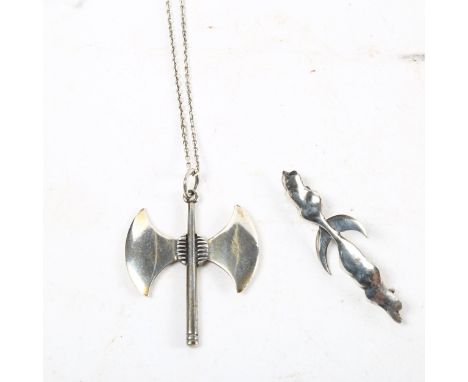 A sterling silver pendant and chain in the form of a Viking axe, and a Viking style silver brooch (2) 