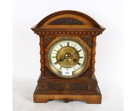 An early 20th century carved walnut-cased 8-day mantel clock with enamel dial, height 36cm 