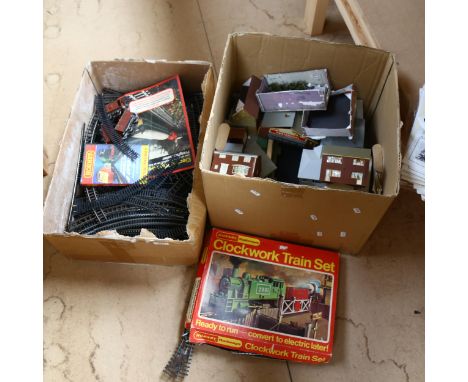 A Hornby clockwork train set (no engine), a large quantity of track and buildings (2 boxes) 
